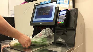 Close up of man paying foods at self-checkout counter