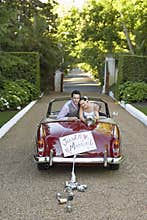 Newlywed Couple In Retro Wedding Car