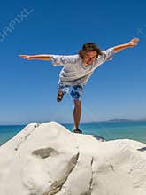 Freedom on the White Cliffs: Young Man Balancing with Joy Above Azure Sea and Blue Sky