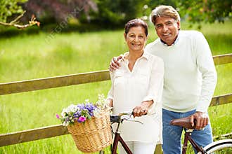 Senior Indian Couple On Cycle Ride In Countryside