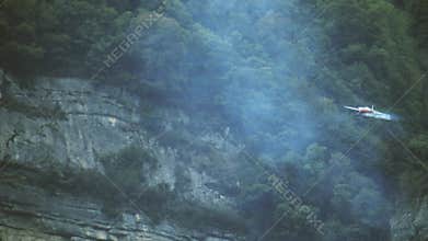 Small airplane performs aerobatics manoeuvres in the French Alps close to Grenoble