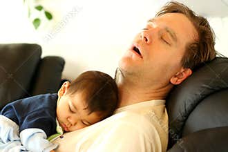 Baby sleeping on dad's chest