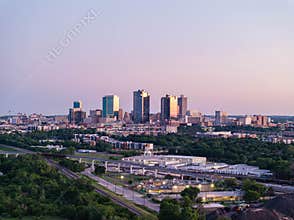 Aerial view of Fort Worth, Texas at dusk, vibrant cityscape, prominent skyscrapers, modern low residential buildings