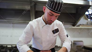 Sous Chef Is Preparing Swordfish In A Restaurant Kitchen