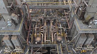Panorama inside of the interior of a chemical plant or oil refinery. Pipeline structure, heavy equipment in process area