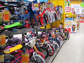 Rows of childrens bikes in a toy store.