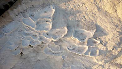 Aerial view of the travertines in Pamukkale in a beautiful sunset, Turkey. White limestone mineral formations. Turkish
