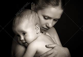 Concept for love and family. mother hugging baby tenderly in mon