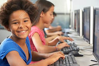 Elementary Students Working At Computers In Classroom