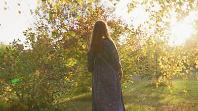Beautiful pregnant woman having walk in the park
