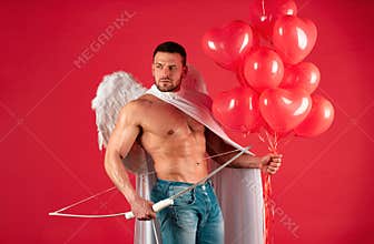 Handsome sexy angels. Valentines day. Muscular guy posing as angel. Cupid in love holding colorful balloons and bow and