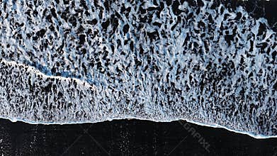 Black sand beach with crashing waves, Serene and tranquil landscape, Ocean coast with calm waves, Famous landmark of