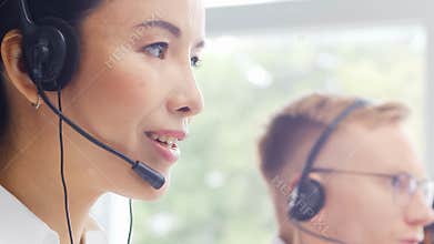 Diverse team of young professionals is working in the phone support office. Working day of sales managers in the call