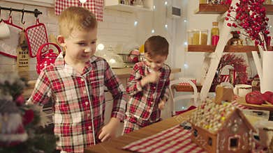Cute boys dancing on the kitchen on Christmas Eve