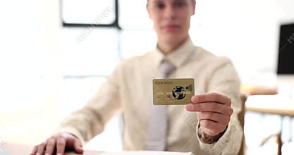 Male banker points to credit card closeup