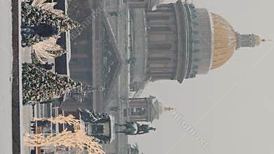 Russia, St Petersburg, 30 December 2023: people walk among Christmas trees in heavy snowfall, a park organized on