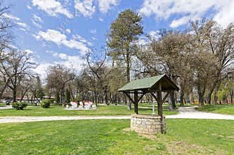 A brick water well with a wooden roof
