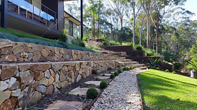 The finished retaining wall in all its glory showcasing its strong and practical design while also blending in with the