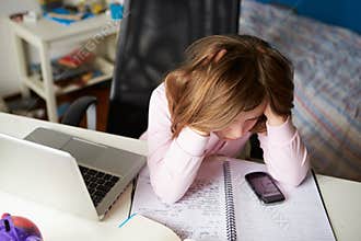 Girl Using Mobile Phone Instead Of Studying In Bedroom
