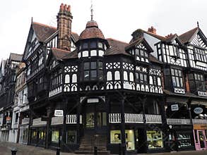 Old half timbered buildings on the corner of Eastgate and stairs leading to the upper rows