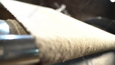 Textured cellulose sheet on roller machine tool in museum