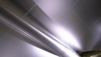 Rotating roller transports paper sheet on production line