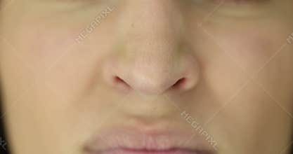 Woman wrinkles nose experiencing itching caused by allergies