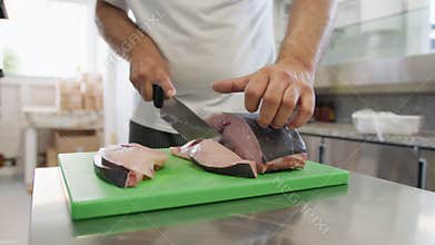 Chef Cuts Swordfish On A Chopping Board To Make As A Second Course