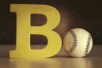 Letter B with a basecball on table