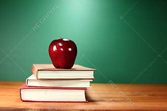 Apple Plus Stack of Books on A Desk for Back to School