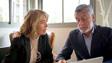 In a contemporary office, professionals collaborate and review papers to enhance productivity