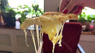 cheese pizza I took a slice of freshly baked pizza with delicious elastic cheese. Delicious Italian pizza baked in an
