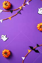 Happy Halloween poster template. Top view Halloween bunting garland, pumpkins, spiders, ghosts, bats on purple background