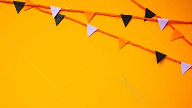 Banner with bunting flag garland for Halloween celebration on orange background