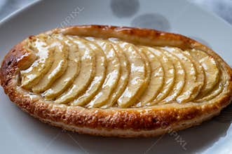 French fresh baked sweet puff pastry with fresh apple fruits in sirup in confectionery shop