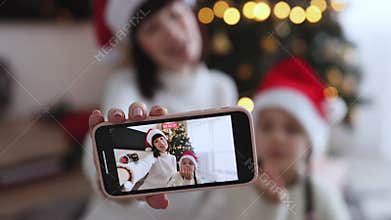 Mother and daughter video call with Christmas tree in the background