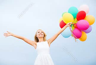 Woman with colorful balloons outside