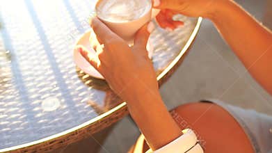 Coffee Hands Cup - Close-up of hands holding a cup of coffee with warm lighting.