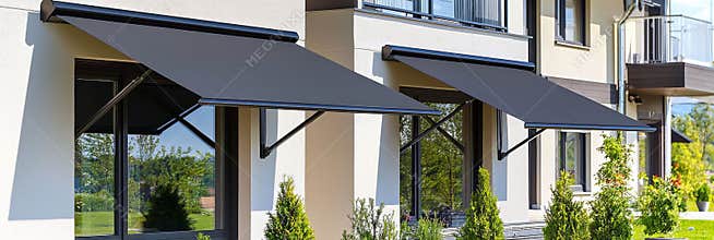 A retractable awning over a large window in a modern home.