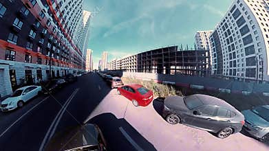 The city is 360 degrees away. Ultra-wide angle. Video distortion. Panorama of a high-rise residential area. Blue sky without