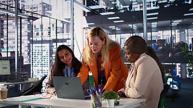 Diverse team of women collaborate in a problem solving meeting