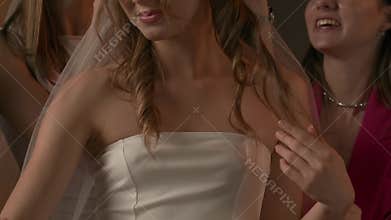 Group of young women friends celebrating bachelorette party at home, close up bride demonstrating to bridesmaids wedding