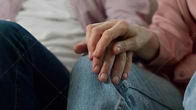 Close-up unrecognizable elderly old people holding hands with wrinkles mature married couple man woman pensioners loving