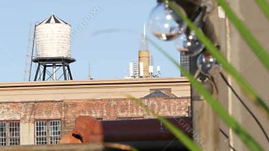 New York City industrial building exterior architecture, USA. Red brick facade. Rooftop water tower.