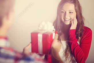 Man handing woman gift