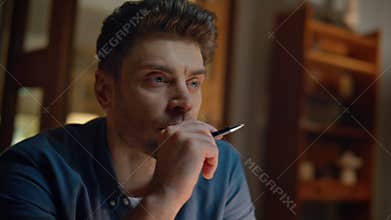 Unknown author writing notebook at evening table closeup. Man thinking ideas