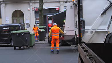 FRANKFURT, GERMANY - JANUARY 31, 2024: Early morning, a garbage truck picks up garbage from garbage cans