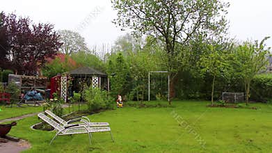 Garden with trees plants hut compost beds lawn in Germany