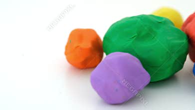 Colorful plasticine balls on a white background.