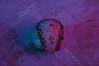 Purple and blue colors over old used baseball ball